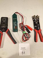 Overall lot showing crimp frame, cable tracer with leads, and wire stripper