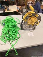 Overall view of both cords: green loose coil, yellow on reel