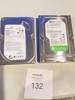 Front view of both hard drives with labels visible