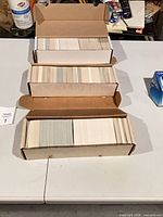 Four open cardboard long boxes filled with hockey trading cards