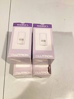 Four boxed Lutron Maestro sensor switches stacked