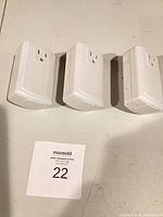 Three white Smartenit smart plugs front view