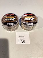 Two sealed rolls of Realtree Advantage Max-4 duct tape on table