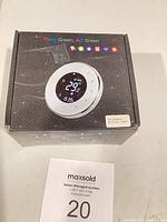 Front of unopened box showing thermostat image and Think Green, Act Green text