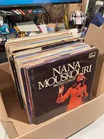 Box containing stack of LP records, front album Nana Mouskouri “British Concert”