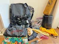 Full lot showing backpack, bear canister, pad, bags, pillow, filtration bag, trowel, water bottle, fuel, mug