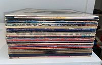 Side view of full stack of approximately 39 vinyl albums