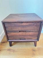 Front view showing two drawers, tapered legs, walnut finish