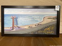 Full view of framed coastal painting