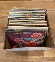 Box with approximately 45 vinyl LPs; front album Todd Rundgren with floral cover visible