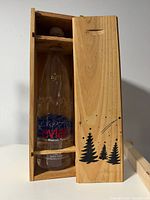 Bottle inside open wooden case showing label and 1997 imprint