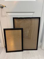 front view of both frames leaning against door