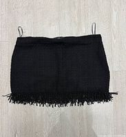 Front view of black beaded hem mini skirt
