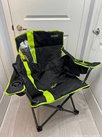 Camp chair opened showing cup holder, pocket and trim