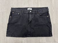 Front view of Mango black wash denim mini skirt