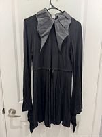 Front view of dress showing shape and bat collar