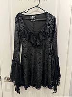 Front view of black Killstar velour dress on hanger