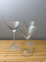Front view showing three martini glasses: two frosted-stem, one clear