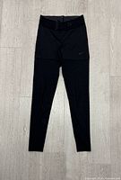 Front view of Nike Dri-Fit leggings with shorts overlay and mesh lower legs