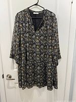 Front view of patterned MNG Suit dress on hanger