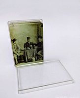 Standard deck in clear plastic case; saloon scene card back visible