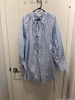 Front view of blue-white striped shirt dress on hanger