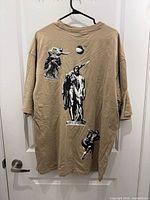 Back view of tan H&M oversized t-shirt with multiple classical statue graphics