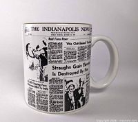 Mug front showing newspaper design and handle