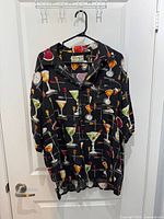 Front view of shirt hanging on door showing martini print and pocket