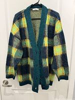 Front view of Mango plaid wool cardigan on hanger