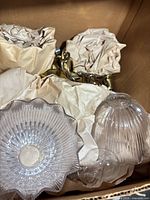 Boxed fixture parts: ribbed glass shade, brass chain, wrapped canopy and hardware