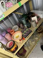 shelf with mixed candles, jar candles, boxed tealights and potpourri glasses