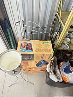 Overview showing champagne bucket, Jane Fonda step box, racks, gas can, packing materials