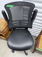 Front view showing mesh back, padded seat, armrests and casters