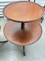 Full view of two-tier mahogany pedestal side table