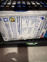 Boxed Mastercraft air compressor kit lying on shelf, side panel with specifications visible