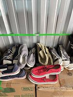 Group of eight pairs of shoes on boxes