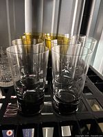Tall smoked and amber highball tumblers with other glassware visible