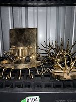 Two brass light fixture frames with sockets and arms visible