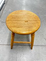 Top view of oak stool showing round seat and finish