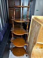 Full view of five-tier walnut display shelf showing overall design and condition