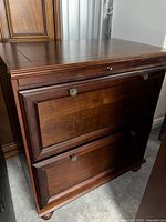 Front view of mahogany 2-drawer lateral file cabinet showing drawers, hardware and bun feet