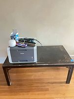 Overall view of coffee table with printer and office items