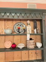 Full shelf view including the carved wooden figure at right side