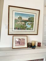 Large framed colour print, small framed photo, candles and incense holder on mantle
