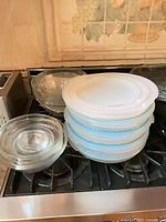 Stack of glass bowls with lids and additional nested glass bowls