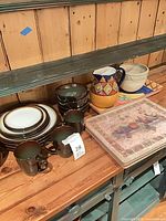 Dinnerware set, pitchers, tray and board on shelf