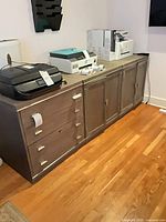 All three gray veneer pieces aligned showing drawers and cabinet doors