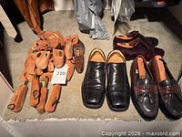 Shoes and cedar shoe trees arranged on shelf