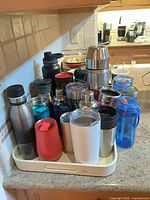 Front view of entire lot showing variety of drinkware on tray